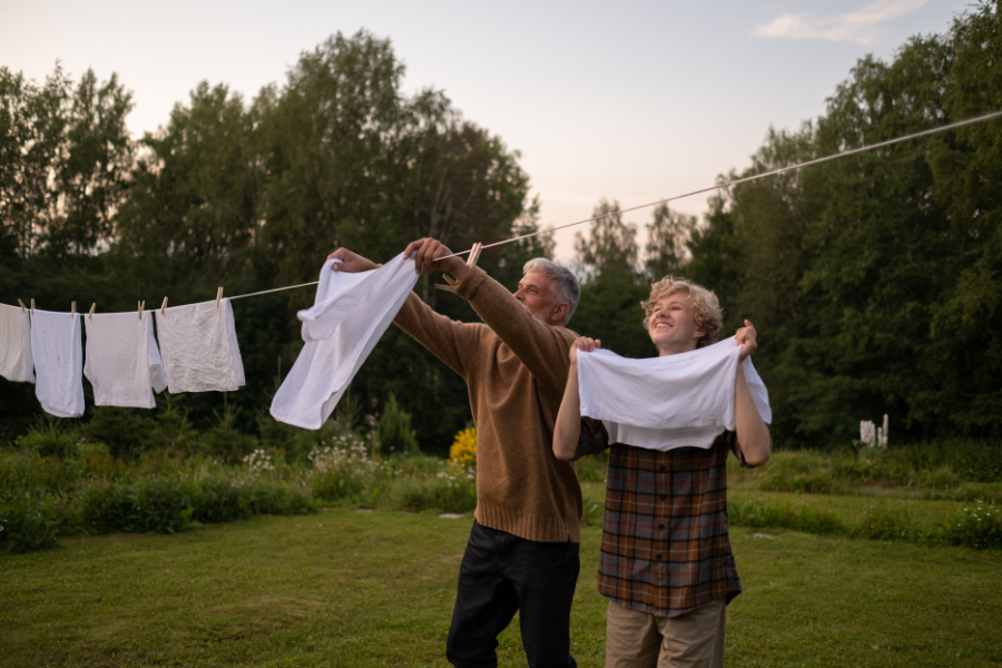 Father son hanging up laundry outside 