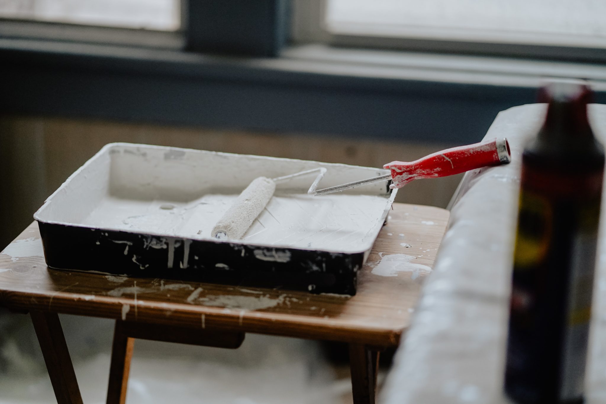 Roller sitting in paint for a home renovation project.
