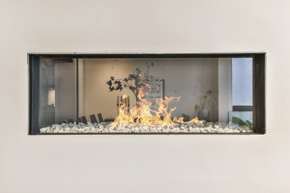 An electric fireplace used to section off two rooms