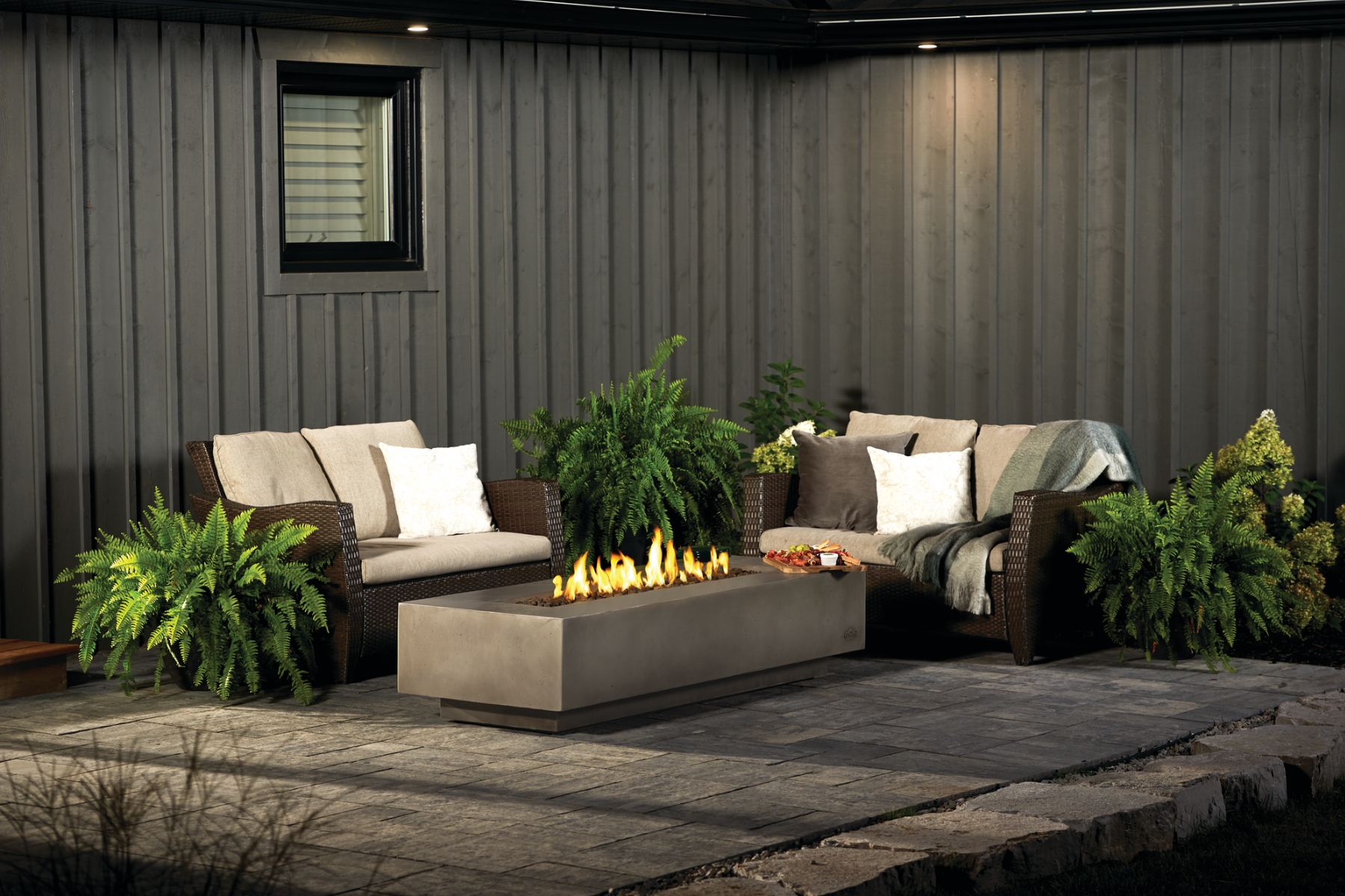 Patio with modern patio set, plants and a firetable