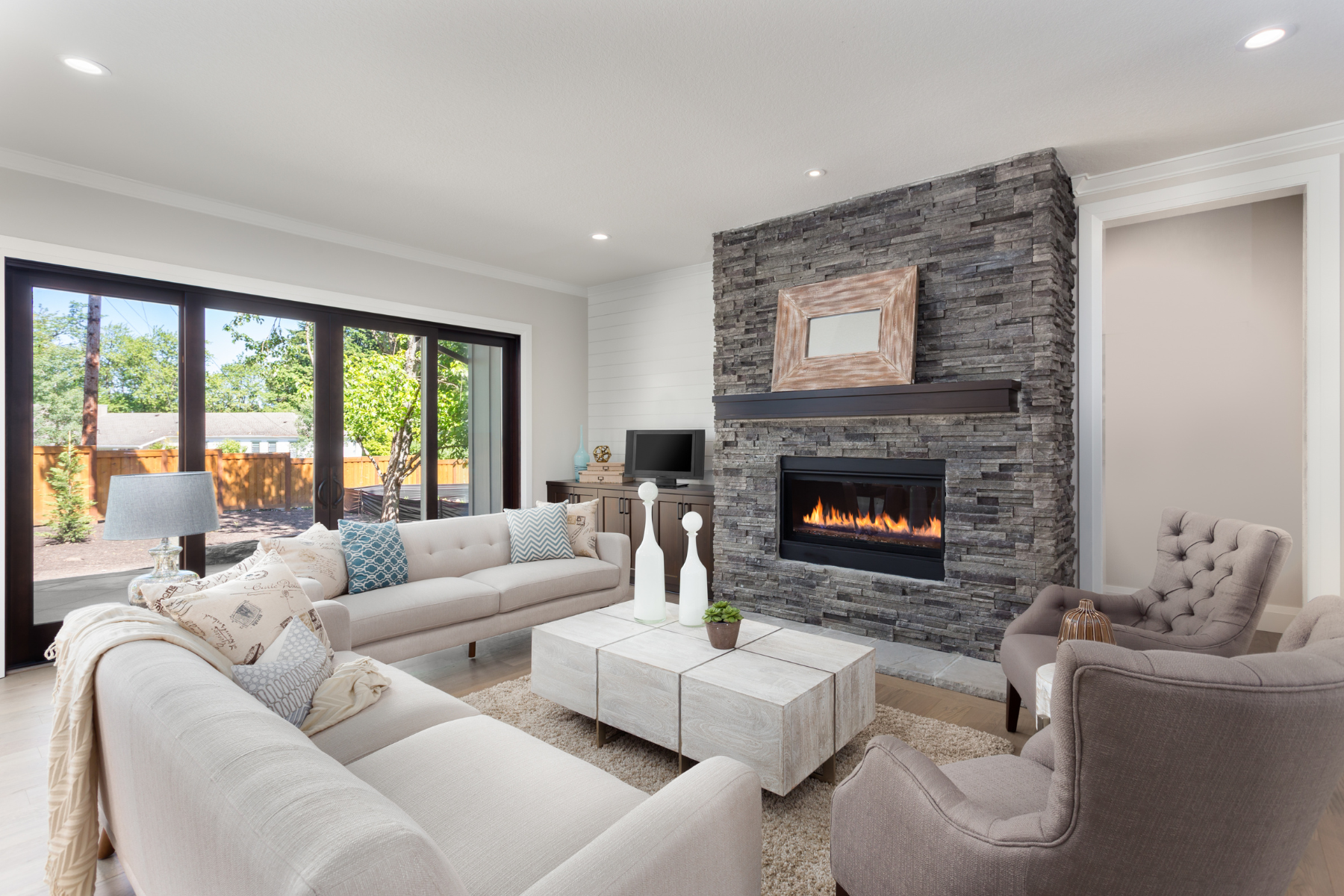 Classic style living room with off-white furnishings and a brick fireplace