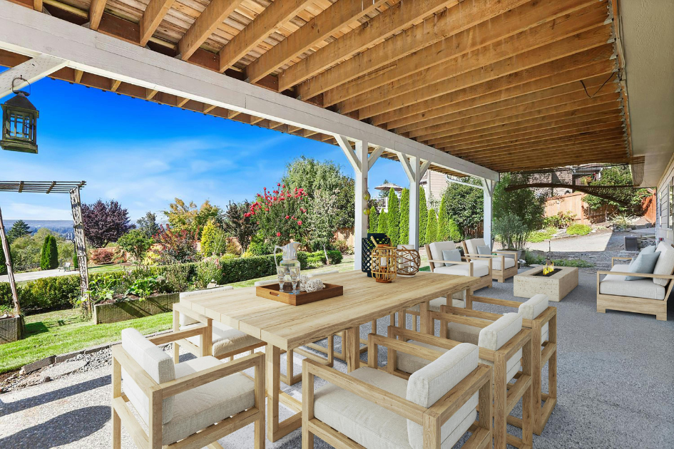 An earth-toned scheme backyard setup split into a seating area and a dining area.